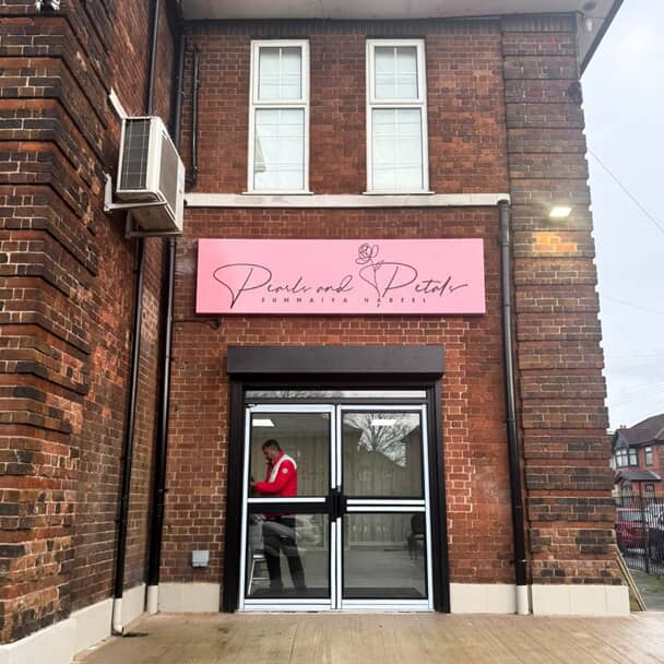 An image of the Pearls and Petals pink outdoor signage.